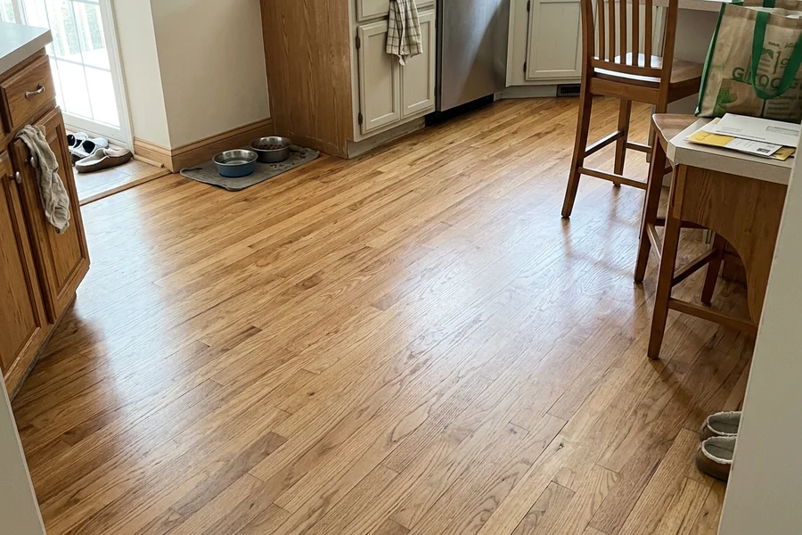 After hardwood refinishing Toronto: kitchen boards replaced and feather-sanded in Humber Bay
