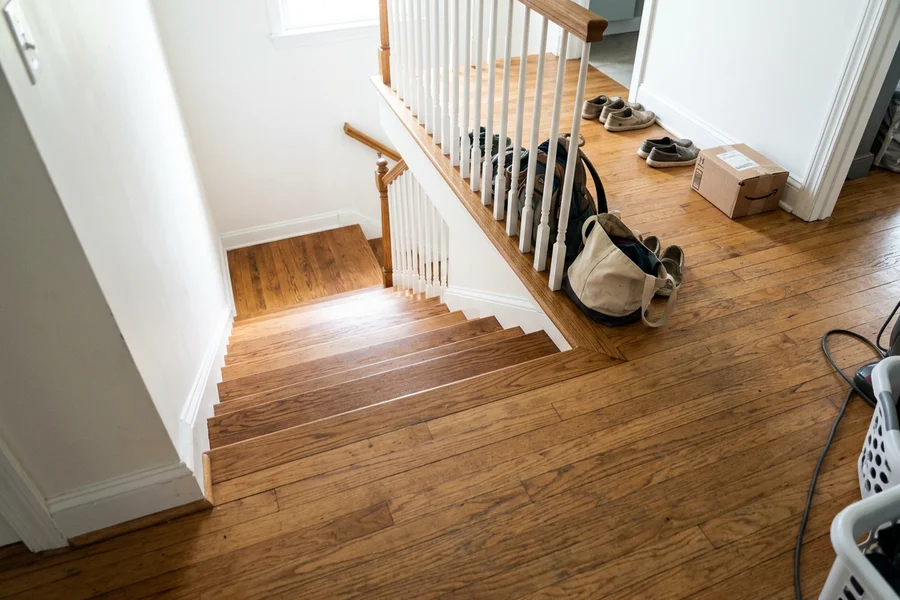 After stair recapping in Toronto: solid oak treads stain-matched to the hallway