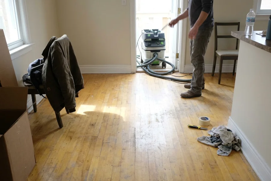 Before hardwood refinishing Toronto: occupied semi, maple floor in Davisville