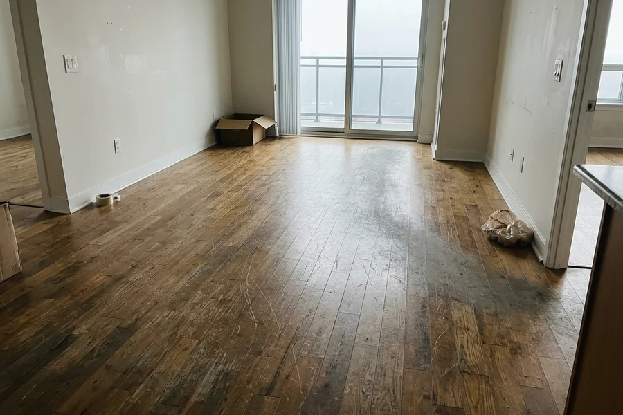 Before engineered hardwood refinishing: scratched condo floor