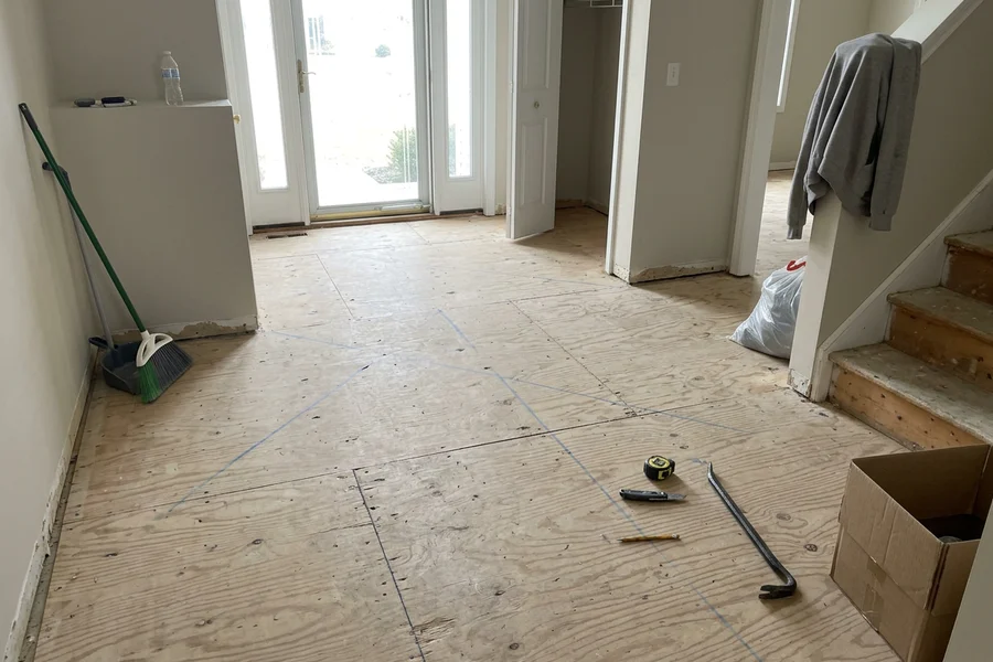 Before hardwood floor installation: bare subfloor in an Erin Mills new build entry