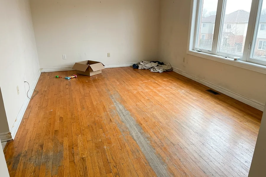 Before hardwood refinishing in a GTA family home: worn oak floor