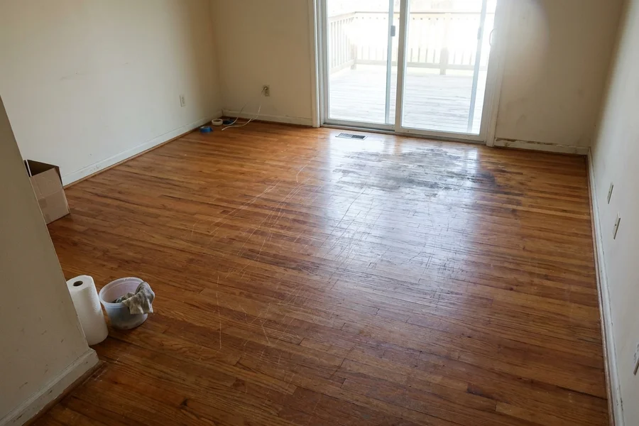 Before hardwood refinishing North York: pet-scratched oak in a Willowdale family room