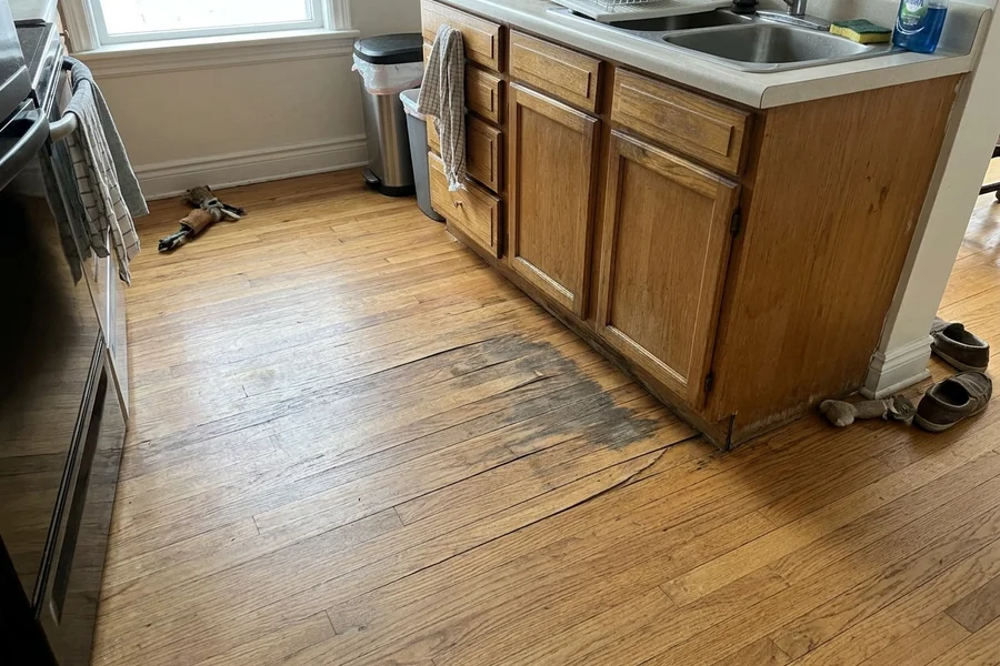 Before hardwood refinishing Toronto: kitchen boards replaced and feather-sanded in Humber Bay