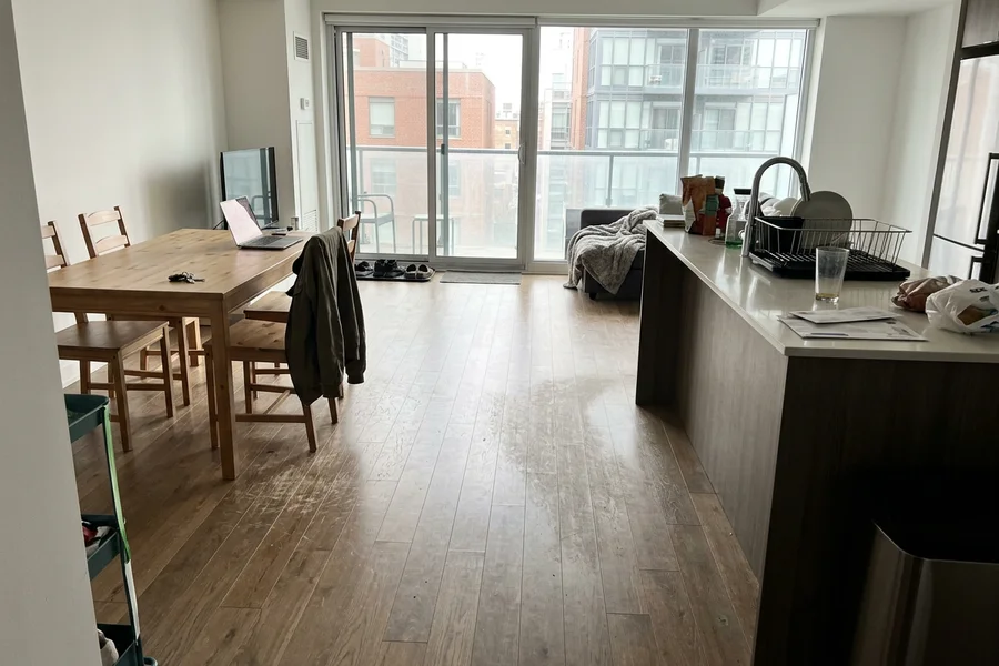 Before hardwood refinishing Toronto: condo engineered oak, open plan in King West
