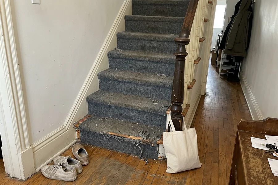 Before stair recapping in Toronto: worn carpeted staircase