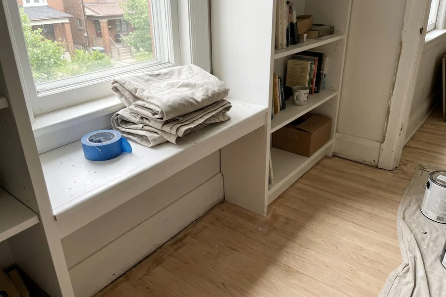 Clean window sill beside a freshly sanded maple floor after HEPA sanding