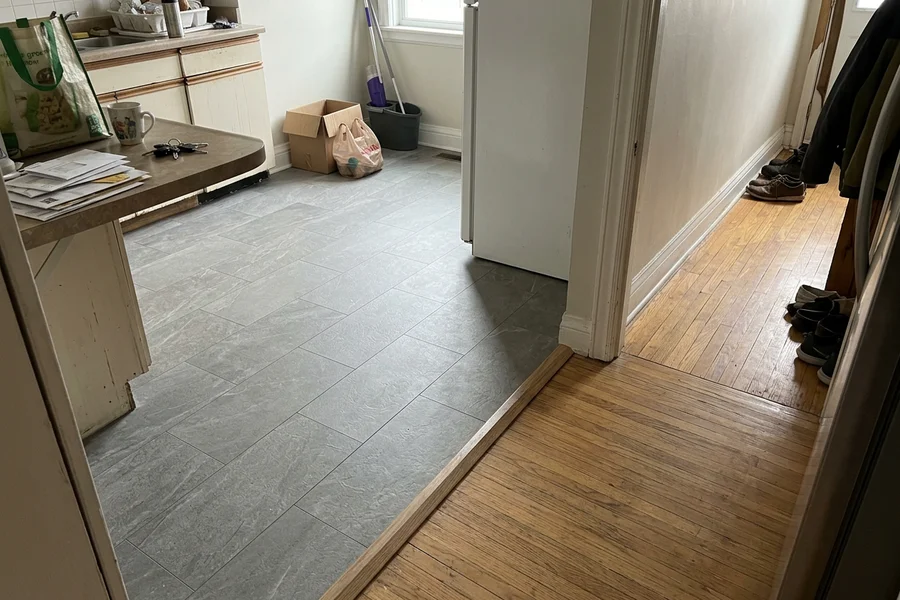 Stone-look LVT in a Toronto kitchen with a clean transition to oak