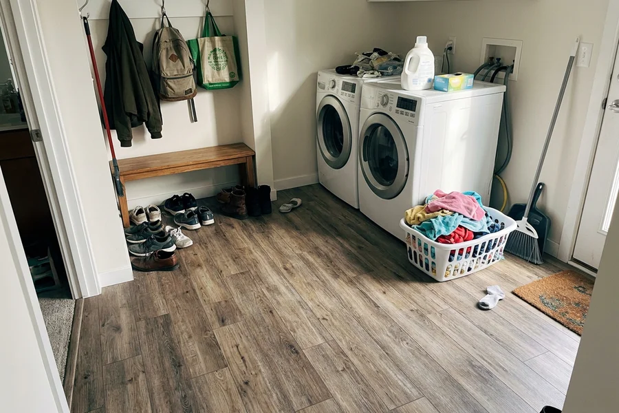 Waterproof vinyl plank in a condo laundry and mudroom