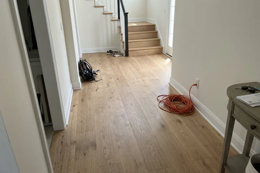 Wide-plank engineered oak hallway refinished in a newer Vaughan home